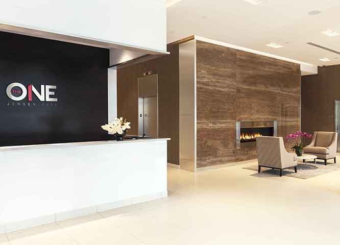 Concierge Desk and Fireplace in the Lobby at The One New Jersey Rentals